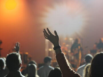 A group of people standing rising hands