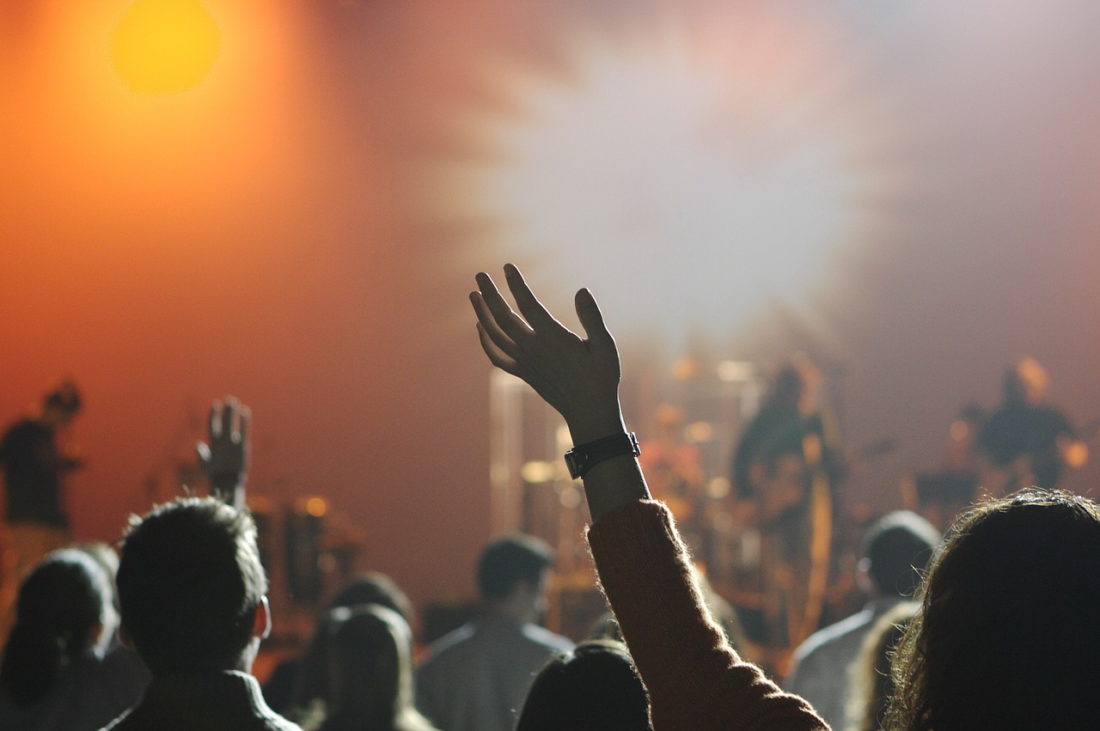 A group of people standing rising hands
